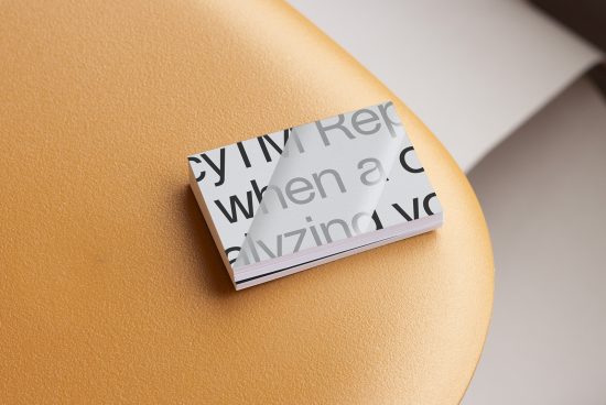 Business card mockup on a tan leather surface with modern typography, showcasing design, print quality, and professional presentation for designers.
